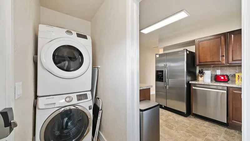 Stacked washer and dryer next to the kitchen.