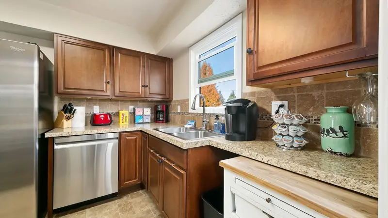 Kitchen counter with a Keurig coffee maker, a toaster and a coffee pod rack, with a dishwasher below.