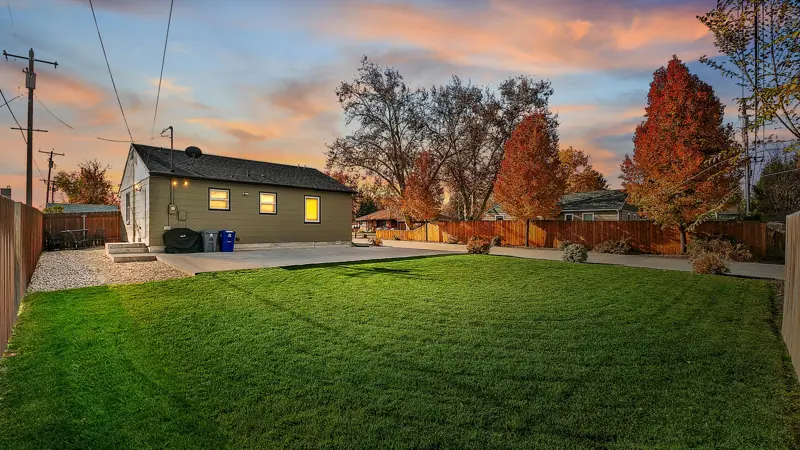 Backyard lawn and the home at sunset.